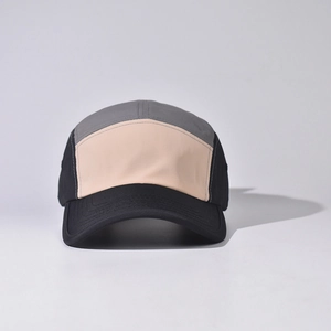 Detail of five-panel sport cap featuring black, grey and peach color-blocking design