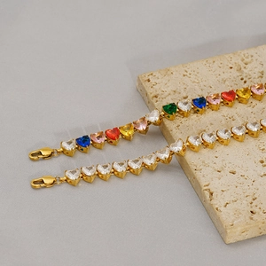 Golden heart-shaped tennis bracelets with rainbow and clear cubic zirconia stones
