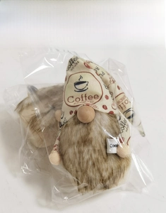 Detail showing the coffee gnome plush toy packaged in a transparent protective bag