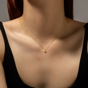 Minimalist S925 sterling silver gold necklace with pear-shaped cubic zirconia on model