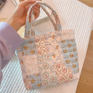Close-up of floral patchwork quilted tote bag with soft cotton texture and simple wish tag