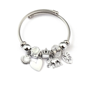 Detail of twisted cable charm bracelet with shell, heart, and crown pendants