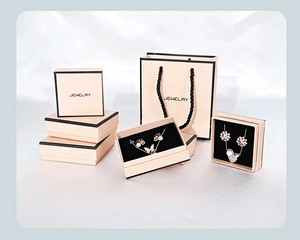 Pink jewelry gift boxes and matching bags with black ribbon detail and jewelry inserts