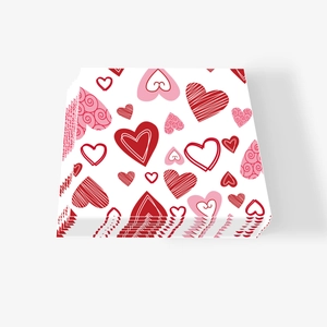 Close-up of stacked Valentine's Day paper napkins with pink and red heart patterns