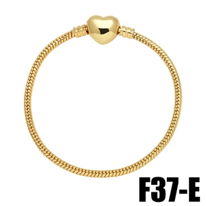 Detail of gold heart clasp and dense snake chain texture with polished finish