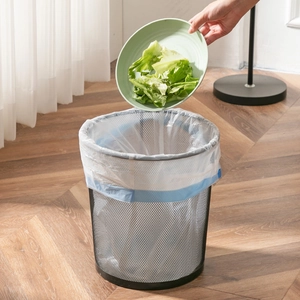 White thickened drawstring kitchen trash bag being used in a home setting