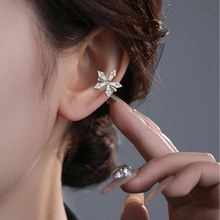 Detail view of leaf and star zircon ear cuffs on a model for a sweet aesthetic