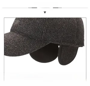 Detail view of winter baseball cap with ear flaps and warm lining in dark grey fabric