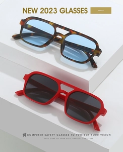 Detail of square double-bridge retro computer glasses in tortoiseshell and bold red frames