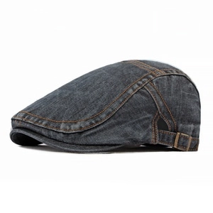 Detail of grey denim flat cap with contrast orange stitching and metal side buckle