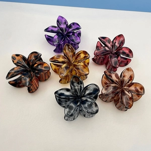 Set of six colorful frangipani hair claws with glossy tortoiseshell textures and floral design