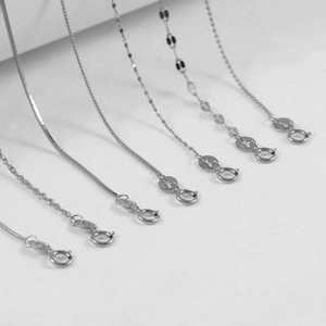 Macro view of assorted S925 sterling silver chain styles including snake and wave links