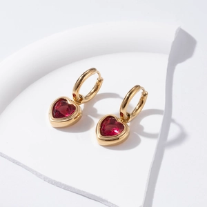 Elegant gold-plated hoop earrings featuring vibrant red heart-shaped zircon pendants