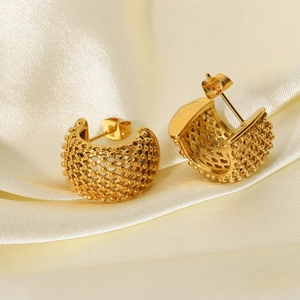 Close-up of 18k gold mesh hoop earrings with beaded texture on beige silk fabric