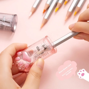 Close-up of pink translucent cat paw pencil sharpener showing internal steel blade
