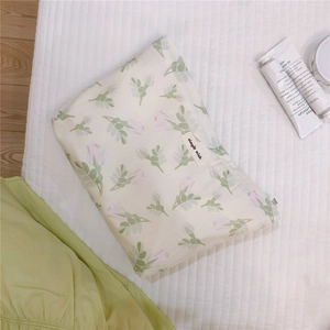 Detail of floral makeup bag with pink rose patterns and 'simple wish' woven label