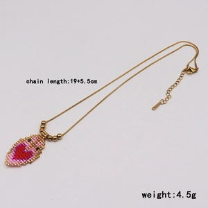 Ethnic heart beaded pendant necklace in pink and red with adjustable gold chain