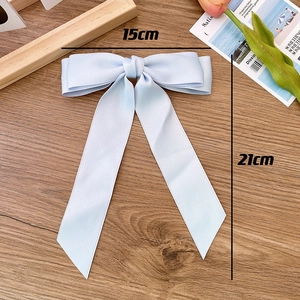 Detail of light blue satin bow hair clip with ribbons measuring 15cm wide and 21cm long