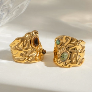 Detail of vintage gold textured rings with turquoise and brown oval stone insets