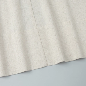 Detailed macro view of beige linen fabric texture and high-quality hem stitching