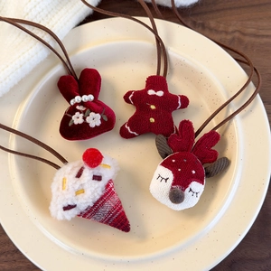 Close-up of cute plush Christmas hair ties including gingerbread man and reindeer designs