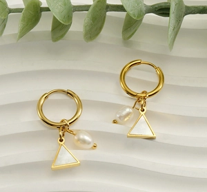 Detail of 18K gold geometric earrings with natural pearl and triangular pendant charms