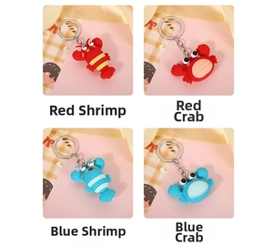 Detailed view of colorful lobster and crab silicone keychains in red and blue styles