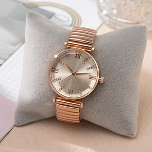 Elegant rose gold ladies watch with elastic metal band and Roman numeral dial accents