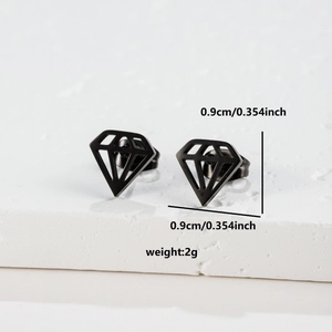 Macro shot of 0.9cm black hollow diamond stud earrings on a textured stone base