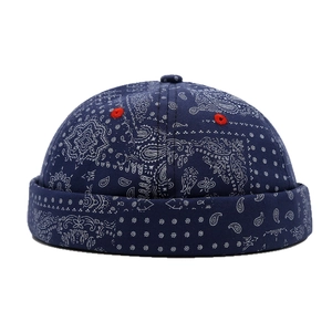 Dark blue paisley brimless docker hat with canvas texture and red embroidery eyelets