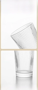 Detail of a ribbed glass cup showing a smooth rounded rim and thickened stable base