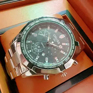 Close-up of mens chronograph watch with dark grey dial and green tachymeter bezel