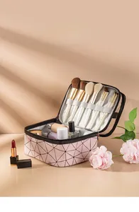Pink quilted makeup bag interior featuring specialized slots for brushes and large storage