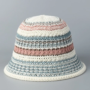 Close-up detail of multi-color striped crochet knit bucket hat with soft summer texture