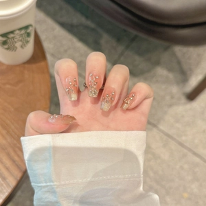 Handmade press-on nails with nude gold glitter gradient and silver rhinestone accents
