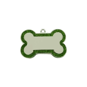 Macro view of a bone-shaped pet ID tag with green glitter border and metal center