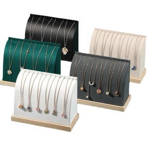 Necklace display stands with solid wood bases in velvet finishes and multiple colors