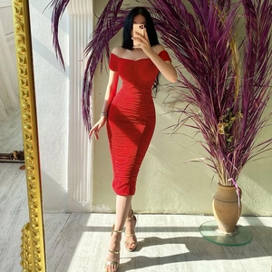 Detail view of red off-shoulder ruched dress with slimming fit and elastic texture