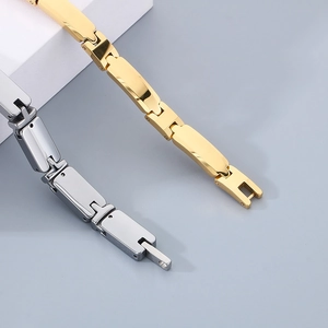 Detail of mechanical linkage and polished finish on gold and silver metal bracelets