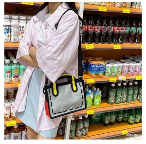 Detailed view of a 2D cartoon style canvas tote bag with bold black outlines and colorful accents