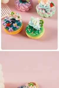 Macro detail of colorful resin donut charms with faux cream and fruit slice toppings