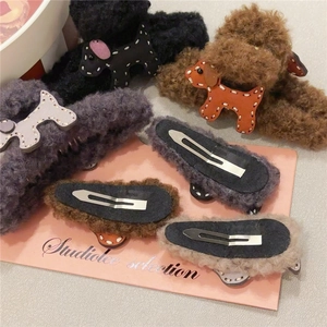 Plush teddy dog hair claws in black, grey and brown tones for elegant hairstyling