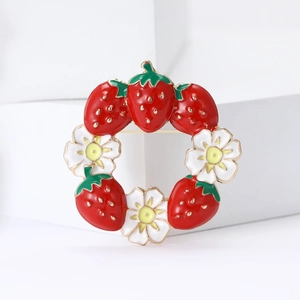 Enamel strawberry and flower wreath brooch in gold metal with vibrant red and white details