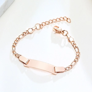 Detailed macro view of rose gold Figaro chain with blank ID plate and lobster clasp