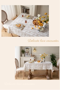 Detailed view of beige lace tablecloth with delicate patterns on a rustic wooden table
