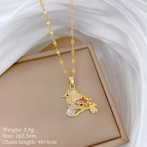 Exquisite gold bird pendant necklace with colorful crystals on elegant silk background