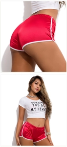 Detail view of red yoga shorts with high-waist fit and graphic t-shirt for fitness