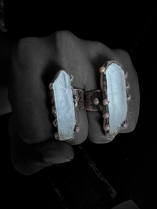 Macro shot of raw white crystal quartz points set in vintage bronze textured rings