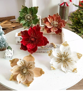 Detailed view of red velvet Christmas flowers with sparkling gold glitter edges