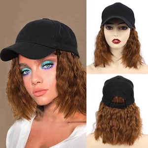 Detail showing a black baseball cap with attached long brown wavy synthetic hair extension